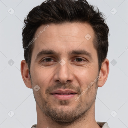 Joyful white adult male with short  brown hair and brown eyes