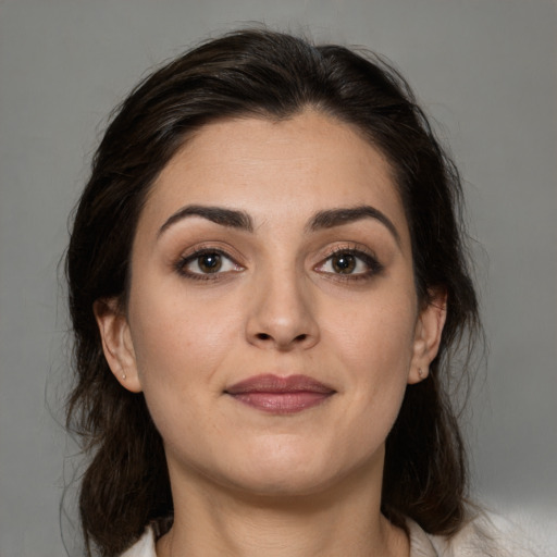 Joyful white young-adult female with medium  brown hair and brown eyes