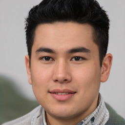 Joyful latino young-adult male with short  brown hair and brown eyes