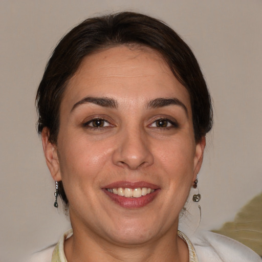 Joyful white adult female with short  brown hair and brown eyes