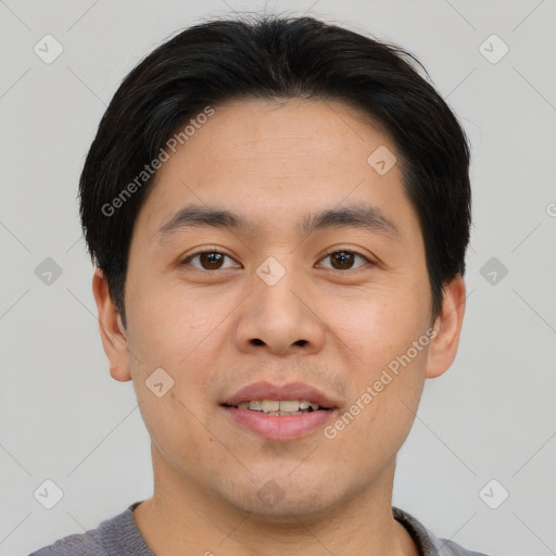 Joyful asian young-adult male with short  brown hair and brown eyes