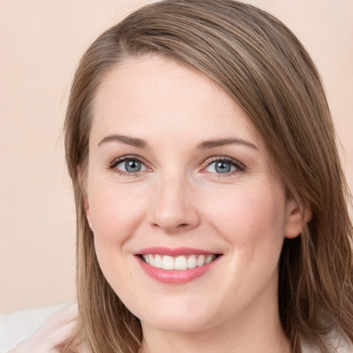 Joyful white young-adult female with long  brown hair and grey eyes