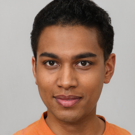 Joyful black young-adult male with short  black hair and brown eyes