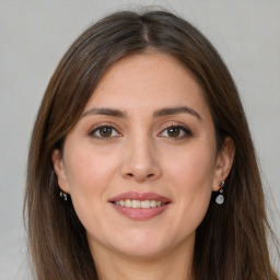 Joyful white young-adult female with long  brown hair and grey eyes