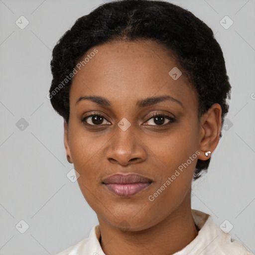 Joyful black young-adult female with short  black hair and brown eyes