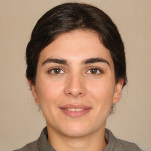 Joyful white young-adult female with medium  brown hair and brown eyes