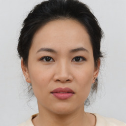 Joyful asian young-adult female with medium  brown hair and brown eyes