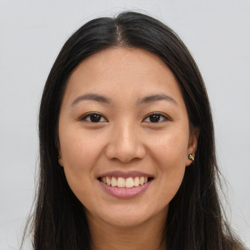 Joyful asian young-adult female with long  brown hair and brown eyes