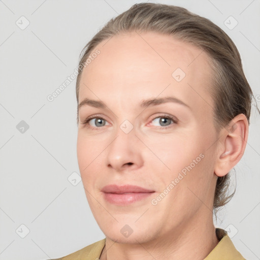 Joyful white adult female with medium  brown hair and grey eyes