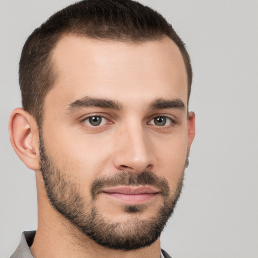 Joyful white young-adult male with short  brown hair and brown eyes