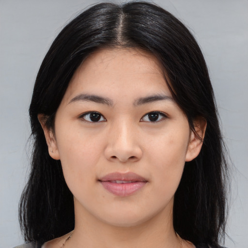 Joyful asian young-adult female with long  black hair and brown eyes