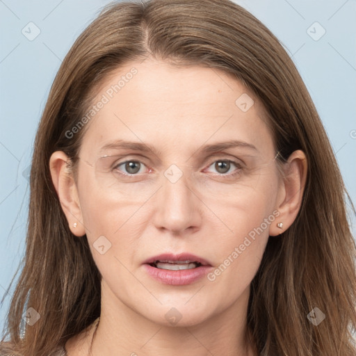 Joyful white adult female with long  brown hair and grey eyes