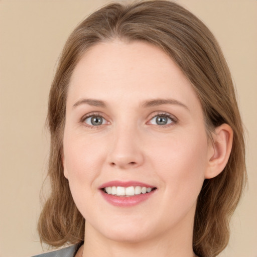 Joyful white young-adult female with medium  brown hair and green eyes