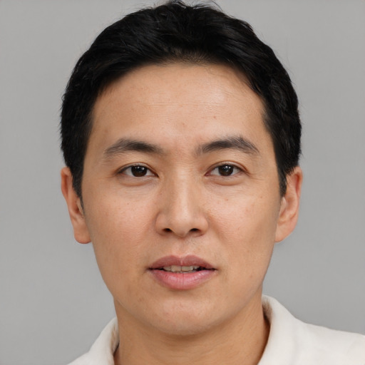 Neutral asian adult male with short  brown hair and brown eyes