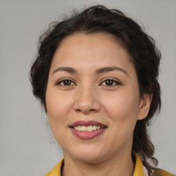 Joyful latino young-adult female with medium  brown hair and brown eyes