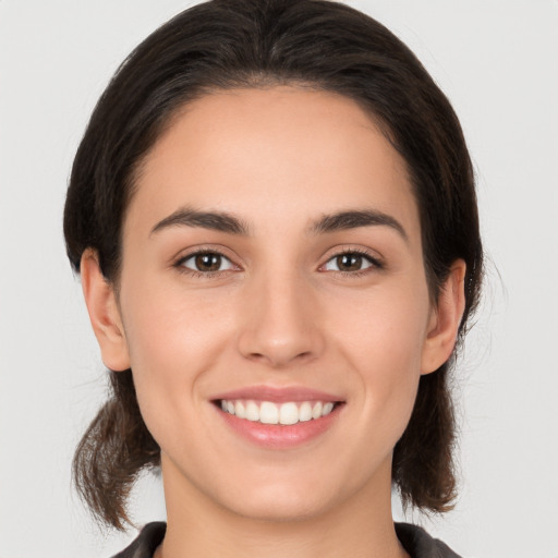 Joyful white young-adult female with medium  brown hair and brown eyes