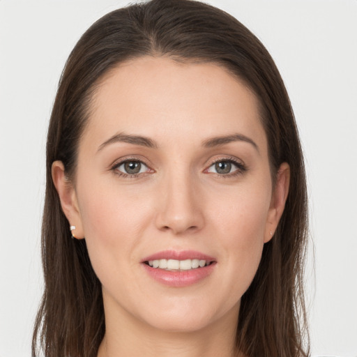 Joyful white young-adult female with long  brown hair and grey eyes