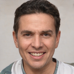 Joyful white adult male with short  brown hair and brown eyes