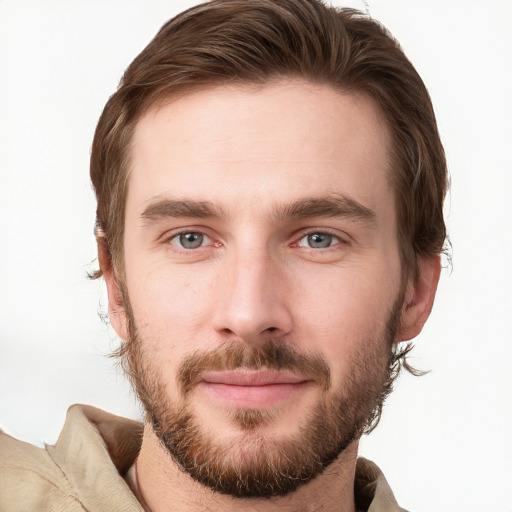 Joyful white young-adult male with short  brown hair and grey eyes