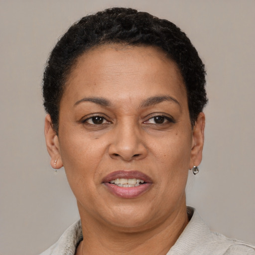 Joyful latino adult female with short  brown hair and brown eyes