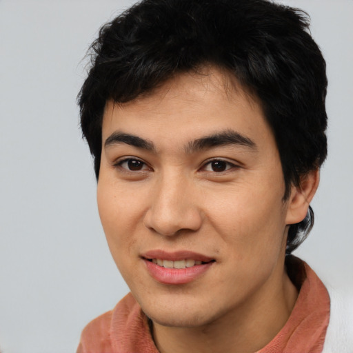 Joyful asian young-adult male with short  brown hair and brown eyes