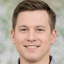 Joyful white young-adult male with short  brown hair and brown eyes