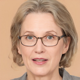 Joyful white adult female with medium  brown hair and blue eyes