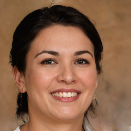 Joyful white adult female with medium  brown hair and brown eyes