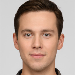 Joyful white young-adult male with short  brown hair and grey eyes