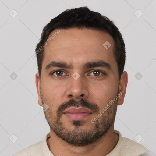 Neutral white young-adult male with short  black hair and brown eyes