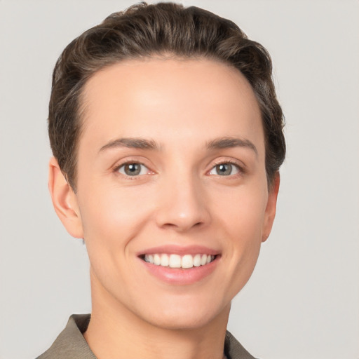 Joyful white young-adult female with short  brown hair and grey eyes