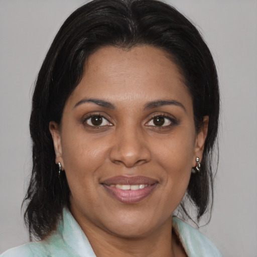 Joyful asian adult female with medium  brown hair and brown eyes