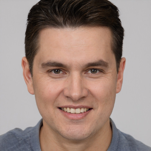 Joyful white adult male with short  brown hair and brown eyes