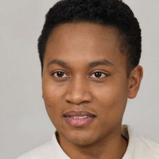 Joyful black young-adult male with short  brown hair and brown eyes