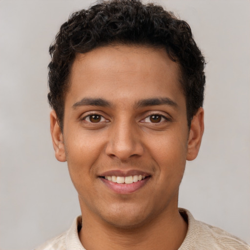 Joyful latino young-adult male with short  brown hair and brown eyes