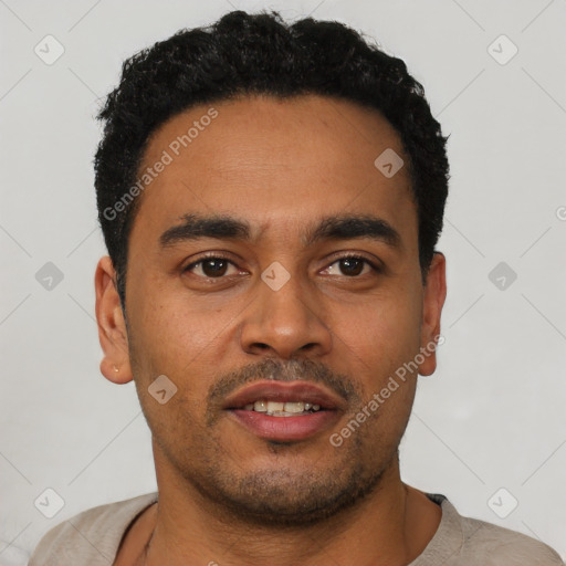 Joyful latino young-adult male with short  black hair and brown eyes