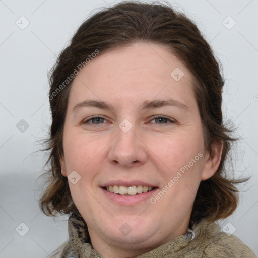 Joyful white adult female with medium  brown hair and grey eyes