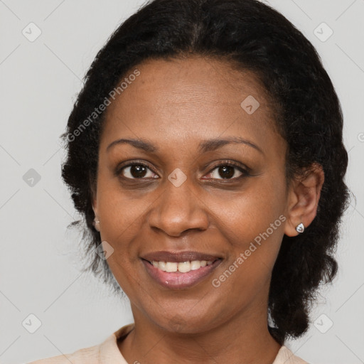 Joyful black adult female with medium  brown hair and brown eyes