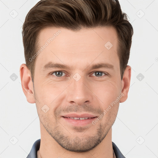 Joyful white young-adult male with short  brown hair and grey eyes