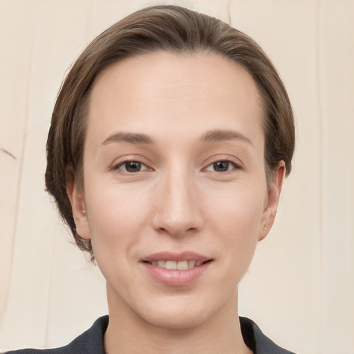 Joyful white young-adult female with medium  brown hair and grey eyes