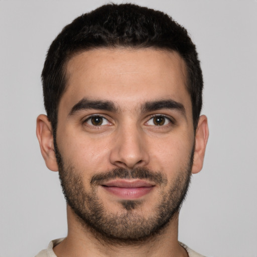 Joyful white young-adult male with short  brown hair and brown eyes