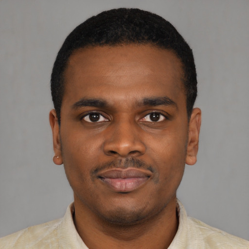 Joyful black young-adult male with short  black hair and brown eyes