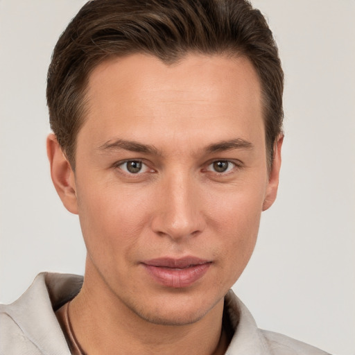 Joyful white young-adult male with short  brown hair and grey eyes