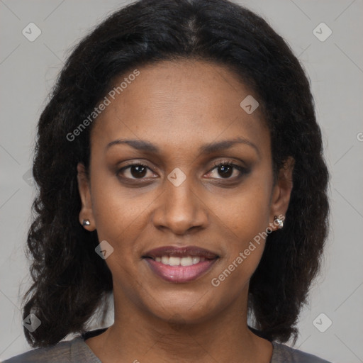 Joyful black adult female with long  brown hair and brown eyes