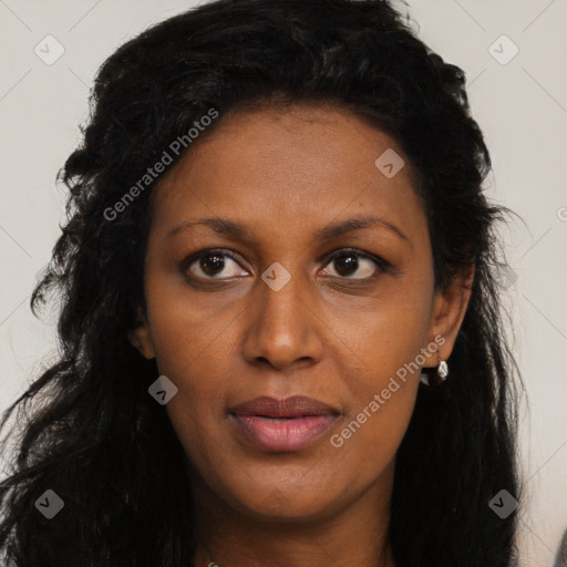 Joyful black young-adult female with long  black hair and brown eyes