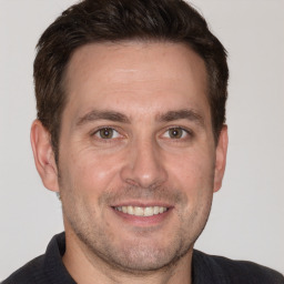 Joyful white young-adult male with short  brown hair and brown eyes