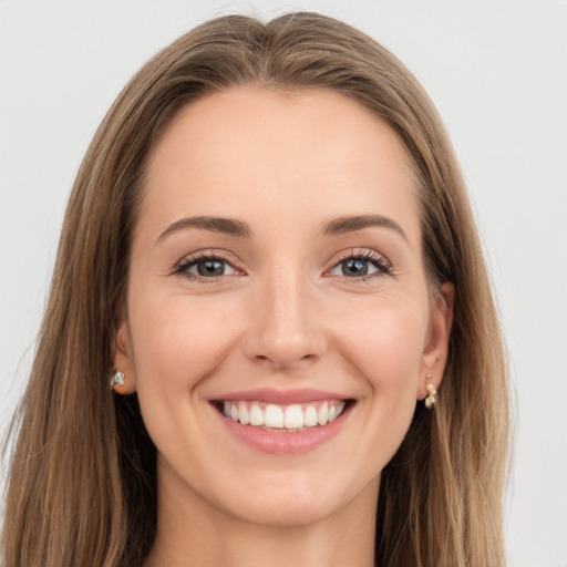 Joyful white young-adult female with long  brown hair and grey eyes