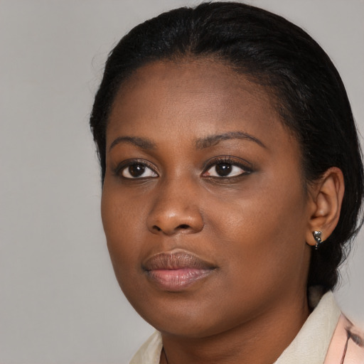 Joyful black young-adult female with medium  brown hair and brown eyes