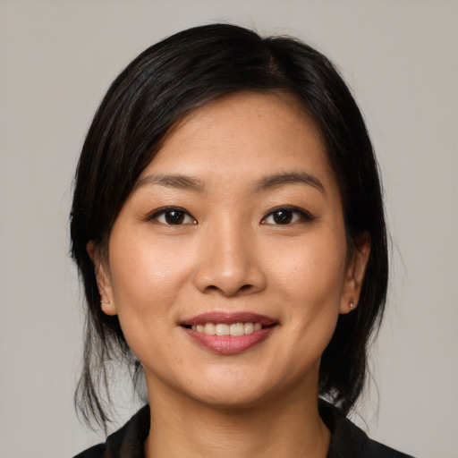 Joyful asian young-adult female with medium  black hair and brown eyes