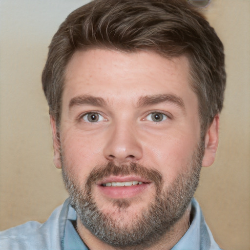 Joyful white adult male with short  brown hair and grey eyes